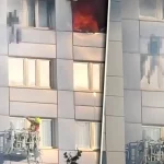 Momentul dramatic în care o femeie sare de la etajul 11, în braţele pompierului, pentru a scăpa de incendiu