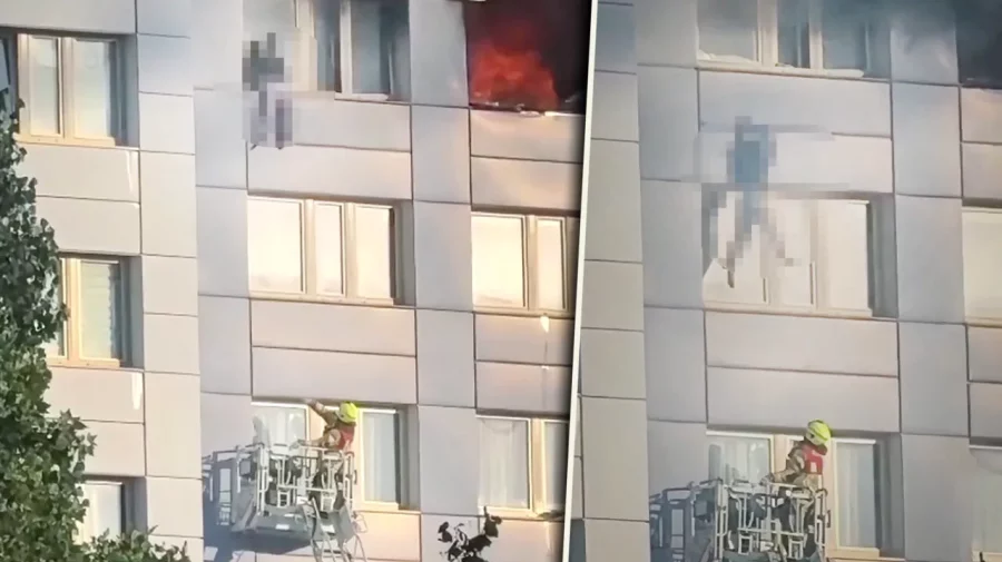 Momentul dramatic în care o femeie sare de la etajul 11, în braţele pompierului, pentru a scăpa de incendiu