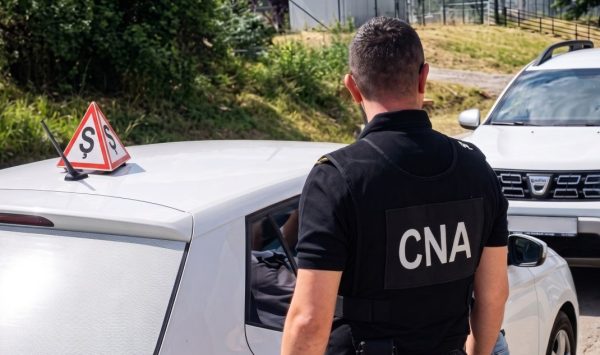 Un instructor auto din Chișinău, încătușat de CNA pentru trafic de influență